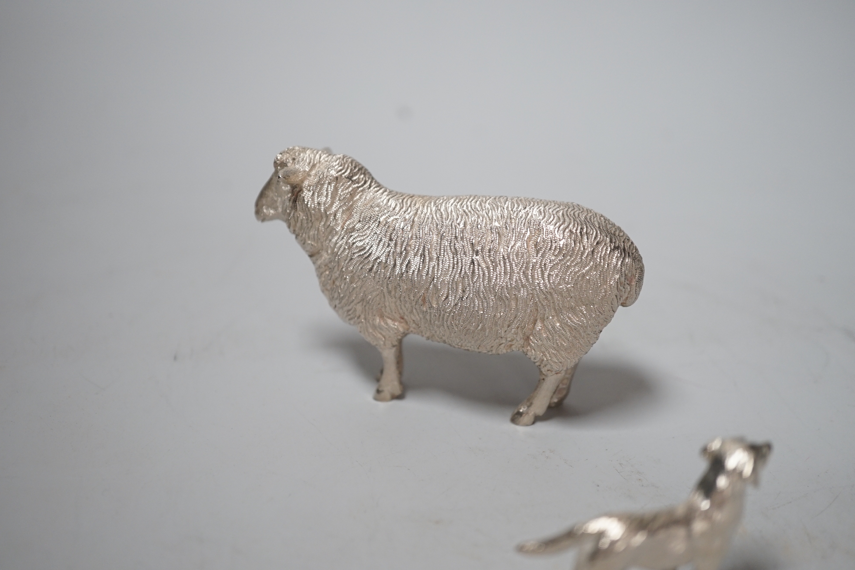 An Elizabeth II silver free-standing model of a sheep, Edward Barnard & Sons Ltd, London, 1993, length 95mm and a smaller silver model free-standing dog, 8.6oz.